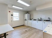 Thumbnail 27 of 45 - A laundry room with a washer and dryer.