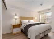 Thumbnail 106 of 108 - a bedroom with a bed and two lamps and a window