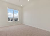 Thumbnail 129 of 144 - A large empty room with a window overlooking a cityscape.