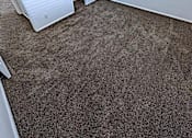 Thumbnail 11 of 14 - A room with a carpeted floor and a white wall.