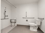 Thumbnail 92 of 92 - A white toilet in a small bathroom with a towel rack and a towel bar at AVIA Lofts on Parkway Apartments, Vancouver, WA