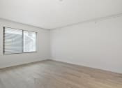 Thumbnail 55 of 61 - the living room of an empty home with white walls and a window at AVIA Lofts on Liberty Ridge, Jacksonville, FL, 32256