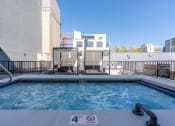 Thumbnail 11 of 84 - a swimming pool with a hot tub and a building in the background at The Revival, Utah, 84101