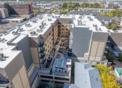 Thumbnail 7 of 84 - arial view of a building in a city with other buildings at The Revival, Utah, 84101