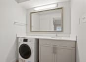 Thumbnail 59 of 61 - a white laundry room with a sink and a washing machine at AVIA Lofts on Liberty Ridge, Jacksonville, FL