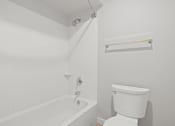 Thumbnail 61 of 61 - a white bathroom with a tub and a toilet at AVIA Lofts on Liberty Ridge, Florida