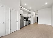 Thumbnail 22 of 55 - A kitchen with white appliances and cabinets is shown.