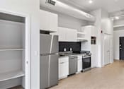 Thumbnail 21 of 55 - A kitchen with white appliances and cabinets.