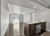 Thumbnail 33 of 41 - the living room and kitchen in a new home with white walls and wood floors