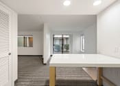 Thumbnail 78 of 92 - A white table is in a room with a carpeted floor. at AVIA Lofts on Parkway Apartments, Vancouver, WA, 98662q