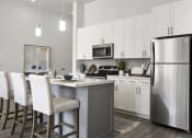 Thumbnail 45 of 83 - a kitchen with white cabinets and stainless steel appliances at 200 City View, Provo, Utah