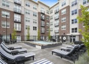Thumbnail 13 of 83 - a courtyard with a hot tub and lounge chairs at the bradley braddock road station at 200 City View, Provo, Utah