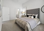 Thumbnail 54 of 83 - a bedroom with a bed and a door to a bathroom at 200 City View, Utah