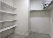 Thumbnail 60 of 83 - a walk in closet with white walls and white shelves at 200 City View, Utah