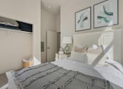 Thumbnail 82 of 83 - a bedroom with a bed and two pictures on the wall at 200 City View, Provo, UT