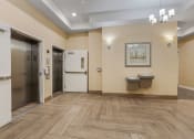 Thumbnail 78 of 83 - a lobby with two elevators and two urinals and a hallway with doors at 200 City View, Provo, UT, 84601