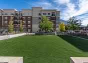 Thumbnail 23 of 83 - a lawn in front of an apartment building with green grass at 200 City View, Provo, Utah