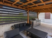 Thumbnail 15 of 83 - a covered patio with couches and a table at 200 City View, Utah