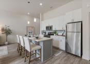 Thumbnail 77 of 83 - an open kitchen and dining area with a stainless steel refrigerator at 200 City View, Provo