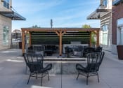 Thumbnail 25 of 83 - a patio with a fire pit and chairs and a wooden pergola at 200 City View, Provo, UT, 84601