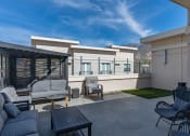 Thumbnail 26 of 83 - a patio with a couch and chairs and a table at 200 City View, Provo, 84601