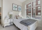 Thumbnail 64 of 83 - a bedroom with a bed and a large window at 200 City View, Provo