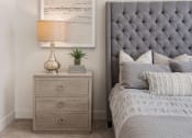 Thumbnail 65 of 83 - a bedroom with a bed with a tufted headboard and a night stand at 200 City View, Utah