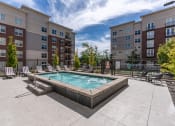 Thumbnail 14 of 83 - our apartments have a resort style pool with lounge chairs and an apartment building at 200 City View, Provo, Utah