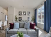 Thumbnail 66 of 83 - a living room and dining room with a couch and a table and chairs at 200 City View, Provo, UT, 84601