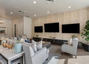 Thumbnail 31 of 83 - a living room with couches and chairs and televisions on the wall at 200 City View, Provo, UT, 84601