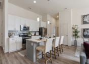 Thumbnail 67 of 83 - an open kitchen and dining area with a table and chairs at 200 City View, Provo, UT