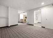 Thumbnail 73 of 92 - A room with a striped carpet and a white door. at AVIA Lofts on Parkway Apartments, Washington, 98662