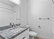 Thumbnail 24 of 55 - A bathroom with a sink, toilet, and a shower.