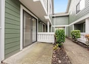 Thumbnail 72 of 92 - A green house with a white fence and a small garden. at AVIA Lofts on Parkway Apartments, Washington