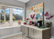 Thumbnail 13 of 41 - a kitchen with a large painting on the wall next to a window
