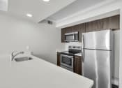 Thumbnail 38 of 41 - a kitchen with stainless steel appliances and a white counter top