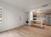 Thumbnail 87 of 92 - A modern kitchen with wooden floors and stainless steel appliances at AVIA Lofts on Parkway Apartments, Vancouver, Washington