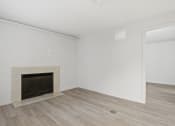 Thumbnail 57 of 61 - the living room of an apartment with a fireplace and wooden floors at AVIA Lofts on Liberty Ridge, Jacksonville, FL