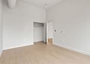 Thumbnail 40 of 55 - A room with a white wall and a wooden floor.