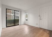 Thumbnail 80 of 92 - A room with a white door and a sliding glass door leading to a balcony at AVIA Lofts on Parkway Apartments, Vancouver, 98662