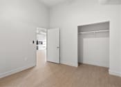 Thumbnail 43 of 55 - A white room with a door and a window.