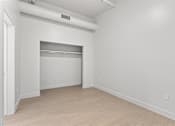 Thumbnail 42 of 55 - A white room with a sliding door and a white wall.