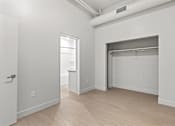 Thumbnail 38 of 55 - A white room with a door and a window.