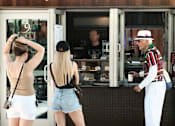 Thumbnail 46 of 61 - Two women are standing outside a cafe at Bautista Apartments, Tucson, AZ