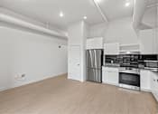 Thumbnail 36 of 55 - A modern kitchen with white cabinets and stainless steel appliances.