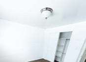 Thumbnail 6 of 14 - A room with a carpeted floor and a white ceiling with a light fixture.