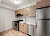 Thumbnail 83 of 92 - A kitchen with a stainless steel refrigerator, oven, and sink at AVIA Lofts on Parkway Apartments, Washington