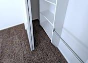 Thumbnail 7 of 14 - A white closet with shelves and a rod for hanging clothes.