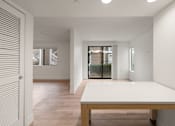 Thumbnail 82 of 92 - A white table is in a room with a white wall and a white door at AVIA Lofts on Parkway Apartments, Vancouver