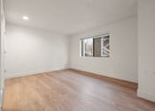 Thumbnail 89 of 92 - Empty room with wooden floor and a window at AVIA Lofts on Parkway Apartments, Washington